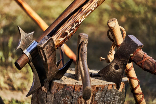 istock Hatchets and axes are stuck in a rustic wooden block 1414986839