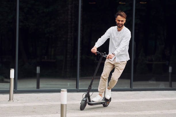 istock Stylish man is with his scooter outdoors at daytime 1414987914