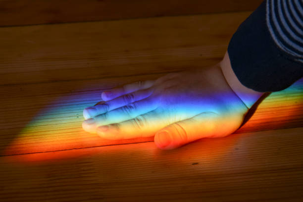 istock Rainbow color sun beam on wooden plank texture. Physical light split effect. LGBT abstract background. 1414988050