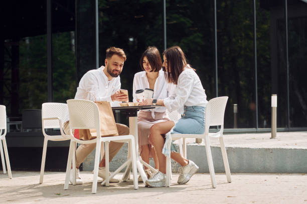 istock Sitting on the chairs. Three friends having great weekend outdoors together 1414988285