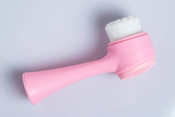 istock Pink face cleansing brush, closeup. Cosmetic accessory 1414989584