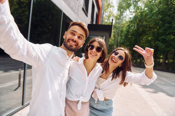 istock Making a selfie. Three friends having great weekend outdoors together 1414989736