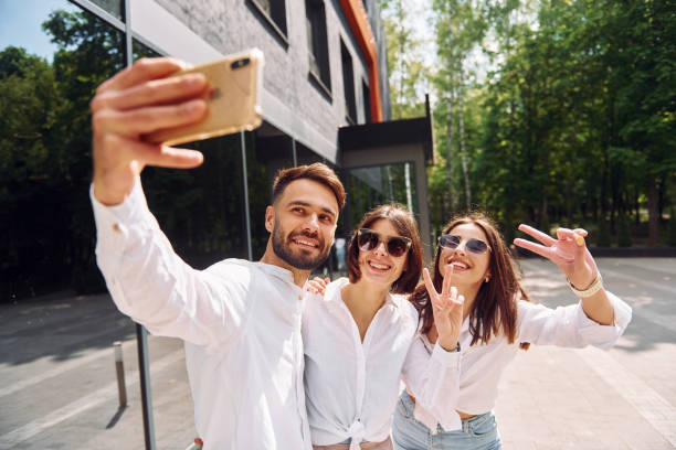 istock Making a selfie. Three friends having great weekend outdoors together 1414989740