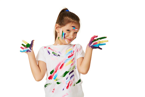 happy little child girl with hands painted in colorful paint isolated on white background.