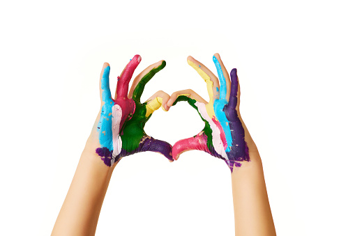 child hands painted in colorful paint make heart shape with love isolated on white background