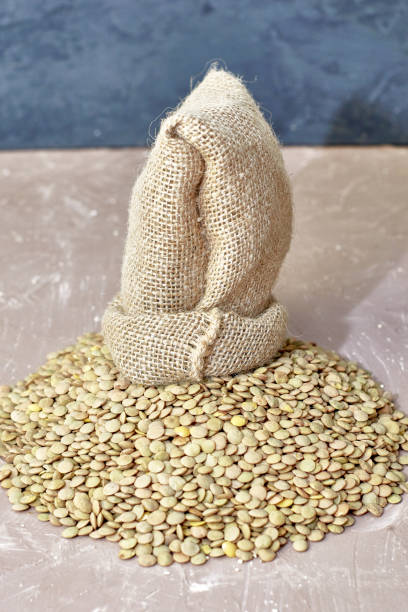 istock lentil grains poured out of a canvas bag on the table 1414990138