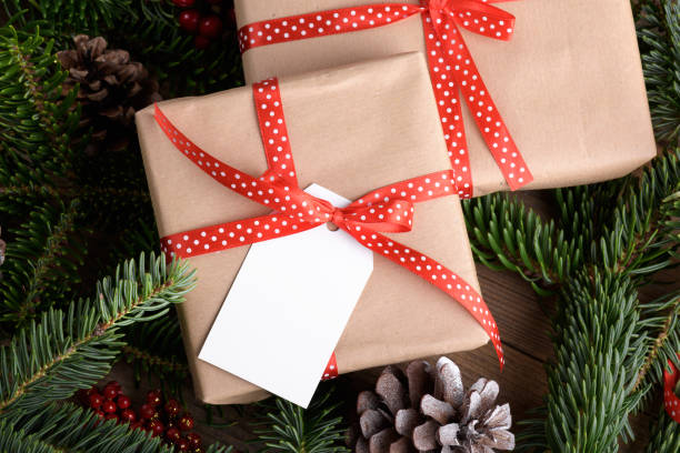 istock Christmas rectangle gift tag mockup with present box, product label mockup, with natural fir tree branch, name tag 1414990492