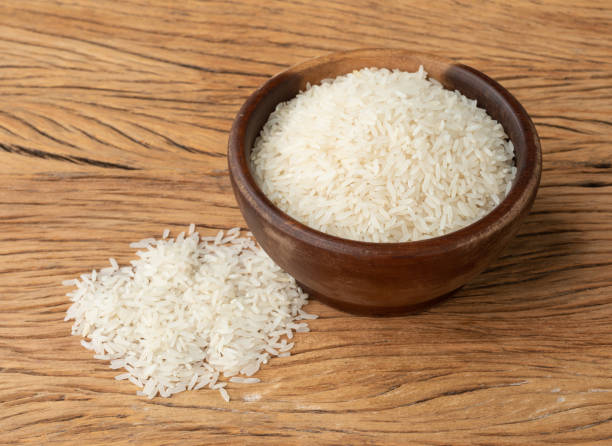 istock Raw white rice in a bowl over wooden table 1414991316