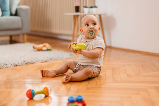 istock Newborn Baby Boy Playing On The Floor 1414995060