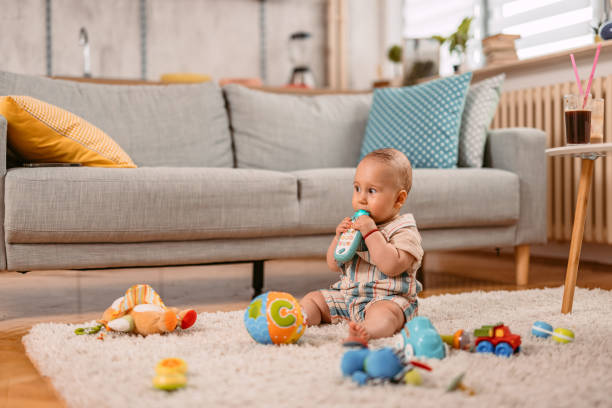 istock Newborn Baby Boy Playing On The Floor 1414995112