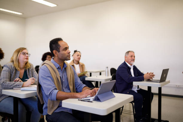 istock Older adults paying attention to university class 1414997042