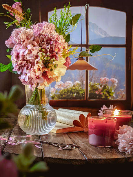 istock a cup of coffee with candle and flowers 1414998429