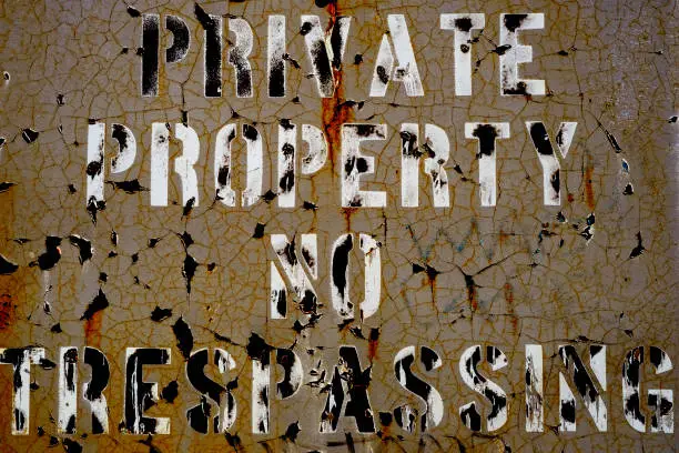 Photo of Private Property No Trespassing Sign Cracked Metal Paint