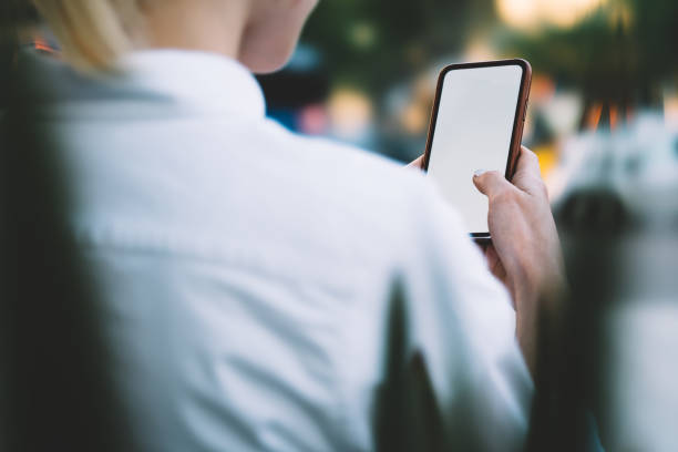 istock Faceless woman touching smartphone screen 1415001872