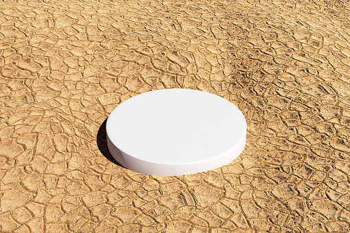 Drought concept, Empty white pedestal podium platform on the dried and cracked dirt