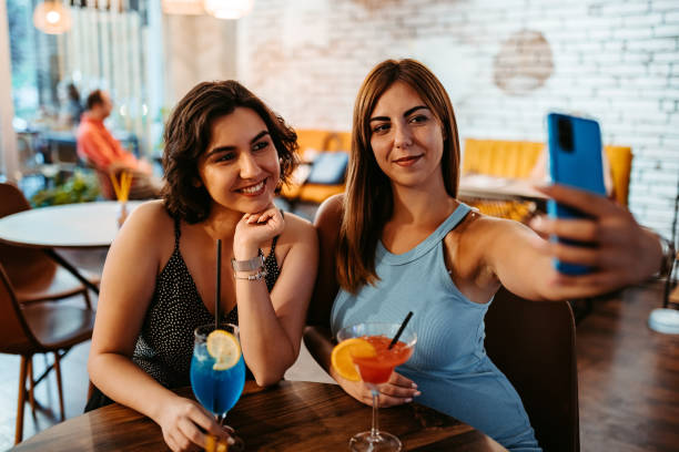 istock Two Friends Taking A Selfie While Enjoying Cocktails On A Night Out 1415003269