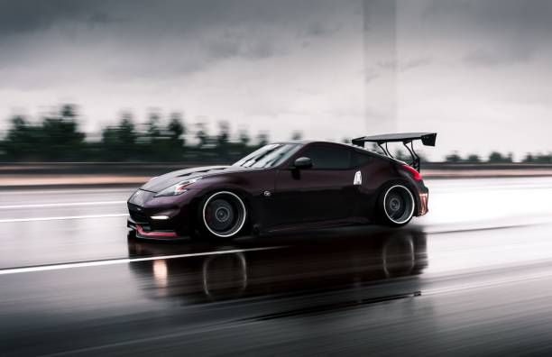 Seattle, WA, USA\n4/12/2022\nRed Nissan 370z driving on the highway in the rain