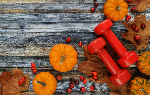 istock Dumbbells, pumpkins and leaves. Autumn composition with copy space. 1415006290