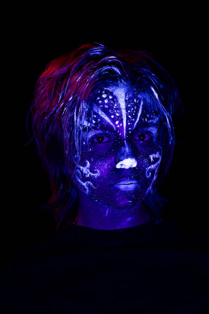 istock Young girl made up with fluorescent colors. 1415008056