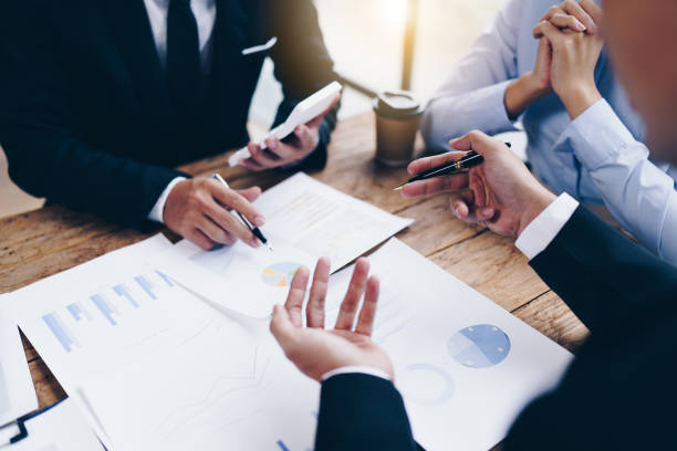 istock business partnership coworkers analysis strategy with discussing a financial planning graph and company budget during a budget meeting in office room. 1415008081