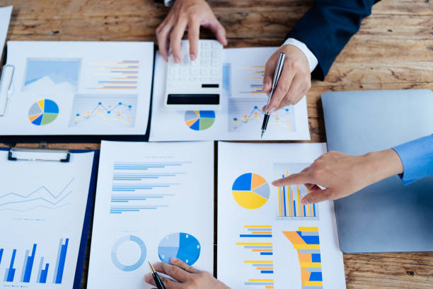 istock business partnership coworkers analysis strategy with discussing a financial planning graph and company budget during a budget meeting in office room. 1415008119