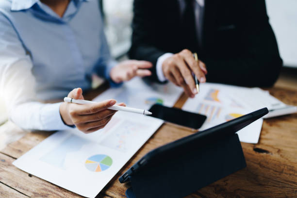 istock business partnership coworkers analysis strategy with discussing a financial planning graph and company budget during a budget meeting in office room. 1415008243