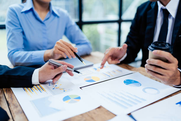 istock business partnership coworkers analysis strategy with discussing a financial planning graph and company budget during a budget meeting in office room. 1415008283