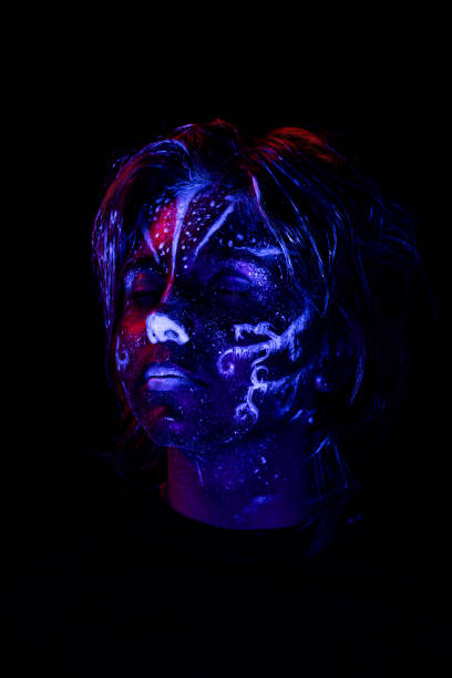 istock Young girl made up with fluorescent colors. 1415008718
