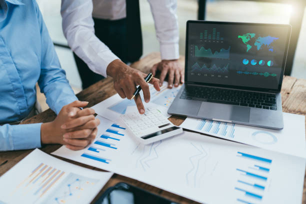 istock business partnership coworkers analysis strategy with discussing a financial planning graph and company budget during a budget meeting in office room. 1415008920