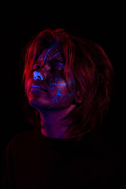istock Young girl made up with fluorescent colors. 1415009861