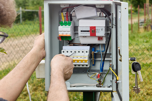 Electrical work on service maintenance of consumer unit of an outdoor switchboard in rural area.