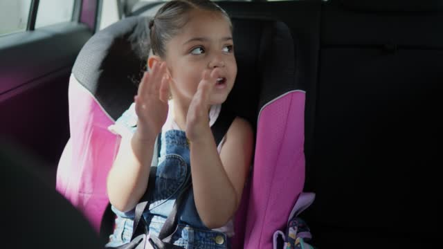 Girl singing and dancing in the car