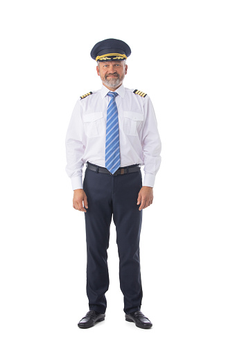 Airline pilot wearing uniform, first pilot, aircraft commander, isolated on white background, full length portrait