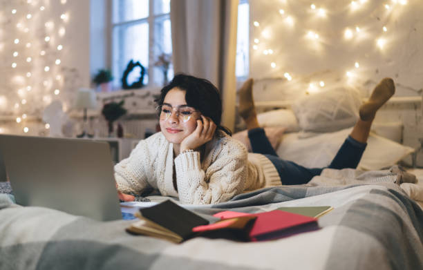 istock Satisfied woman working on laptop remotely 1415014801