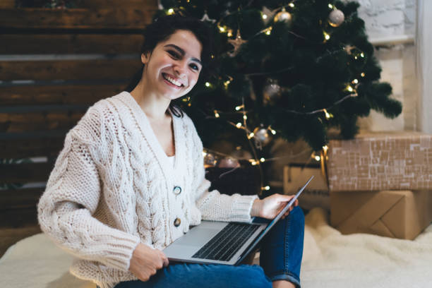 istock Cheerful young female remote worker using laptop in cozy room 1415014813