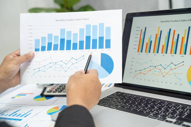 istock Asian accountant working and analyzing financial reports project accounting with chart graph and calculator in modern office, finance and business concept. 1415014855