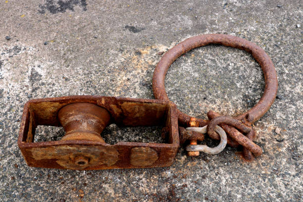 istock Old Rusting Steel Pulley and Ring at a Coastal Harbour Location 1415015791