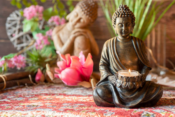 istock Buddha figurine in the ambience with candlelight and atmospheric lighting 1415015939