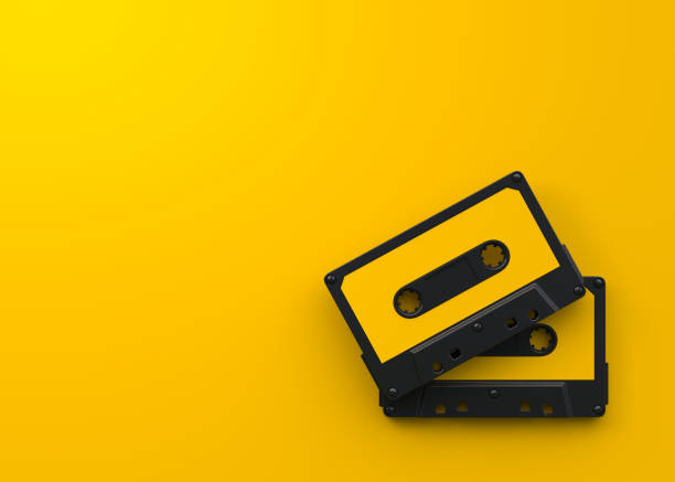 istock Two vintage audio tape cassettes on a yellow background 1415016833