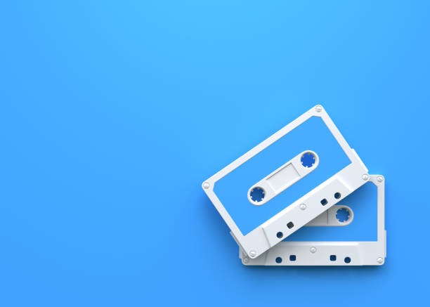 istock Two vintage audio tape cassettes on a blue background 1415016841