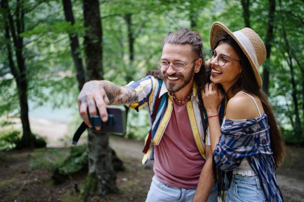 istock Young adults taking selfie in the forest 1415017543