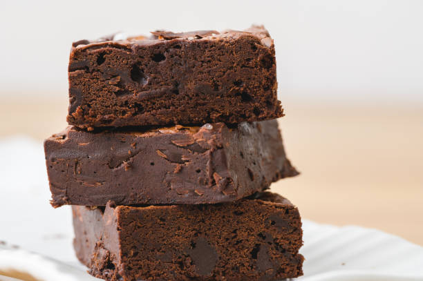 A huge homemade brownie looks appetizing with richness chocolate fudge. A huge homemade brownie that looks appetizing with the richness of chocolate fudge packed into the cake. Fudge stock pictures, royalty-free photos & images