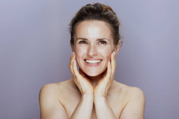 istock smiling young female on blue 1415022625