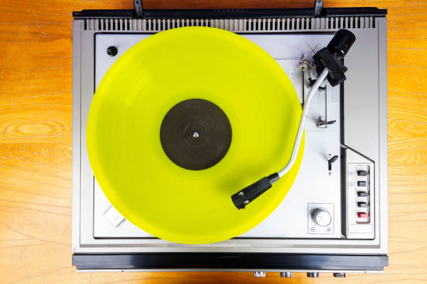 istock Vintage turntable vinyl record player with yellow vinyl 1415023323