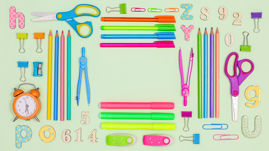 Pastel green background with copy space and Back to school stationery. Flat lay