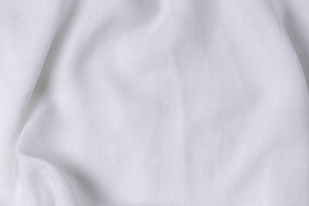 istock White crumpled linen fabric texture background. Natural linen organic eco textiles canvas background. Top view 1415025825
