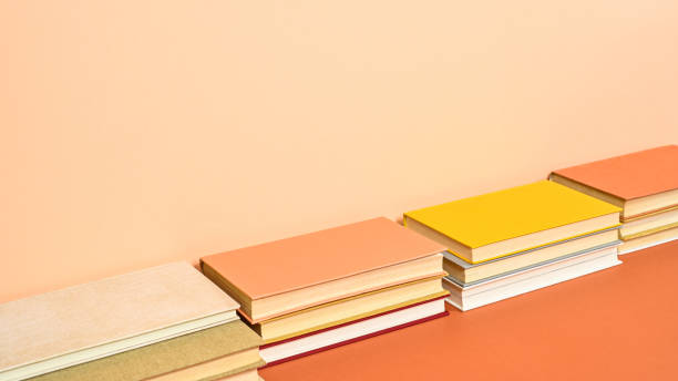 istock Creative hardcover vintage books on two shade orange background. Flat lay 1415027087