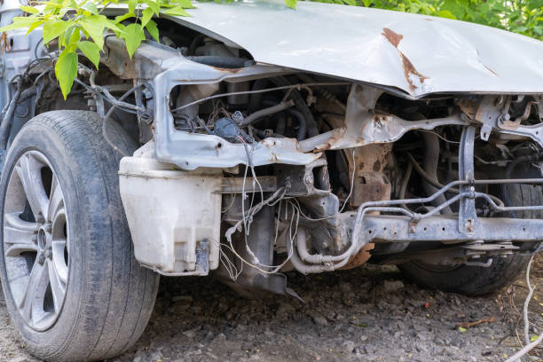 The broken body of an old rusty car with an electric drive, without a bumper. A wrecked car after an accident The broken body of an old rusty car with an electric drive, without a bumper. A wrecked car after an accident. Recycling of old cars. purchase of steel scrap stock pictures, royalty-free photos & images