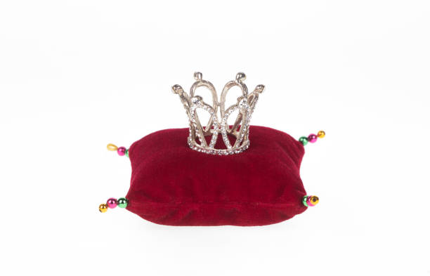 istock crown on red pillow isolated on white background 1415029903
