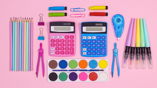 Creative back to school layout with school stationery on pastel pink background. Flat lay concept